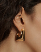 Veronica Beard A shiny, thick gold-toned square hoop earring with a rounded, open bottom.