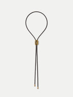 Veronica Beard Black braided leather bolo tie with gold hardware.