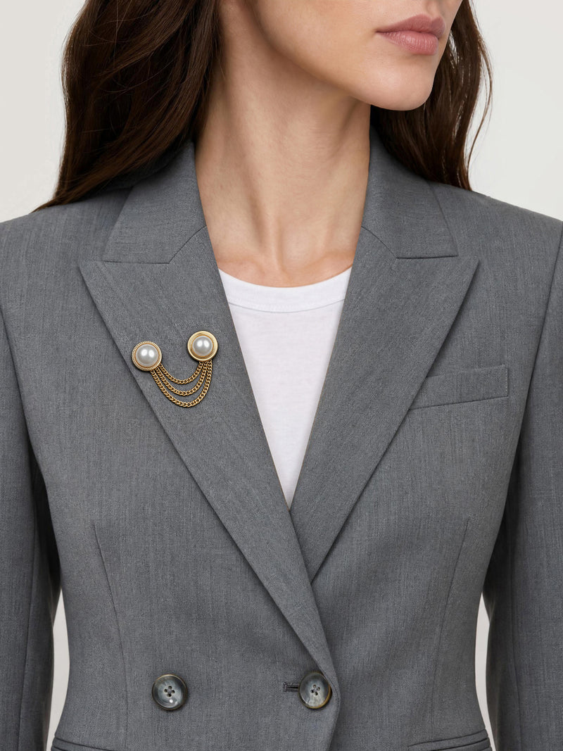 Veronica Beard Grey tailored blazer with pearl chain brooch.