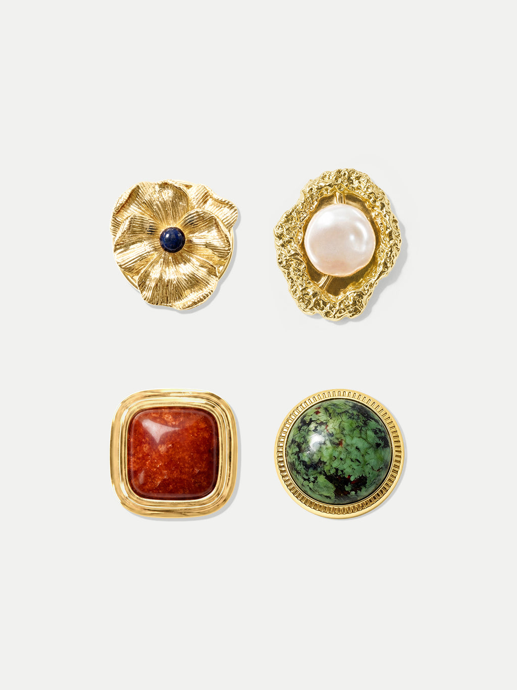 Veronica Beard Four gold gemstone buttons with unique designs.