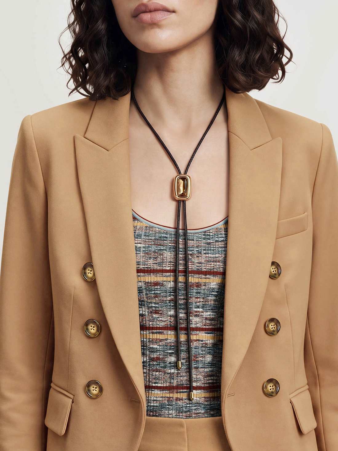 Veronica Beard Camel double-breasted blazer, matching trousers, striped top.