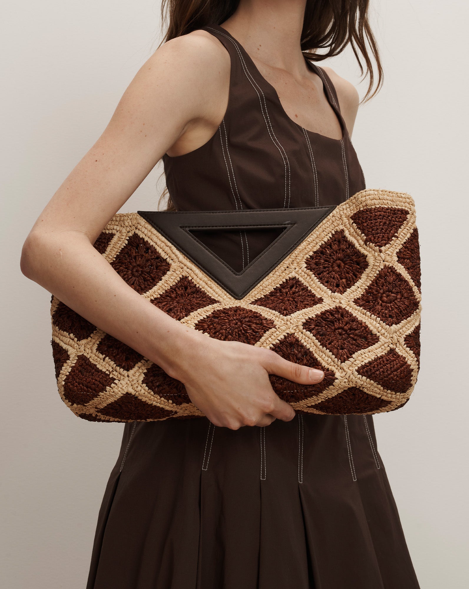 Veronica Beard Brown sleeveless midi dress with white stitching and a pleated skirt.
