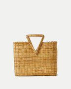 Veronica Beard Natural woven straw tote bag with a triangular top handle.