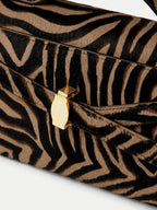 Veronica Beard Brown and black zebra print handbag with gold clasp.