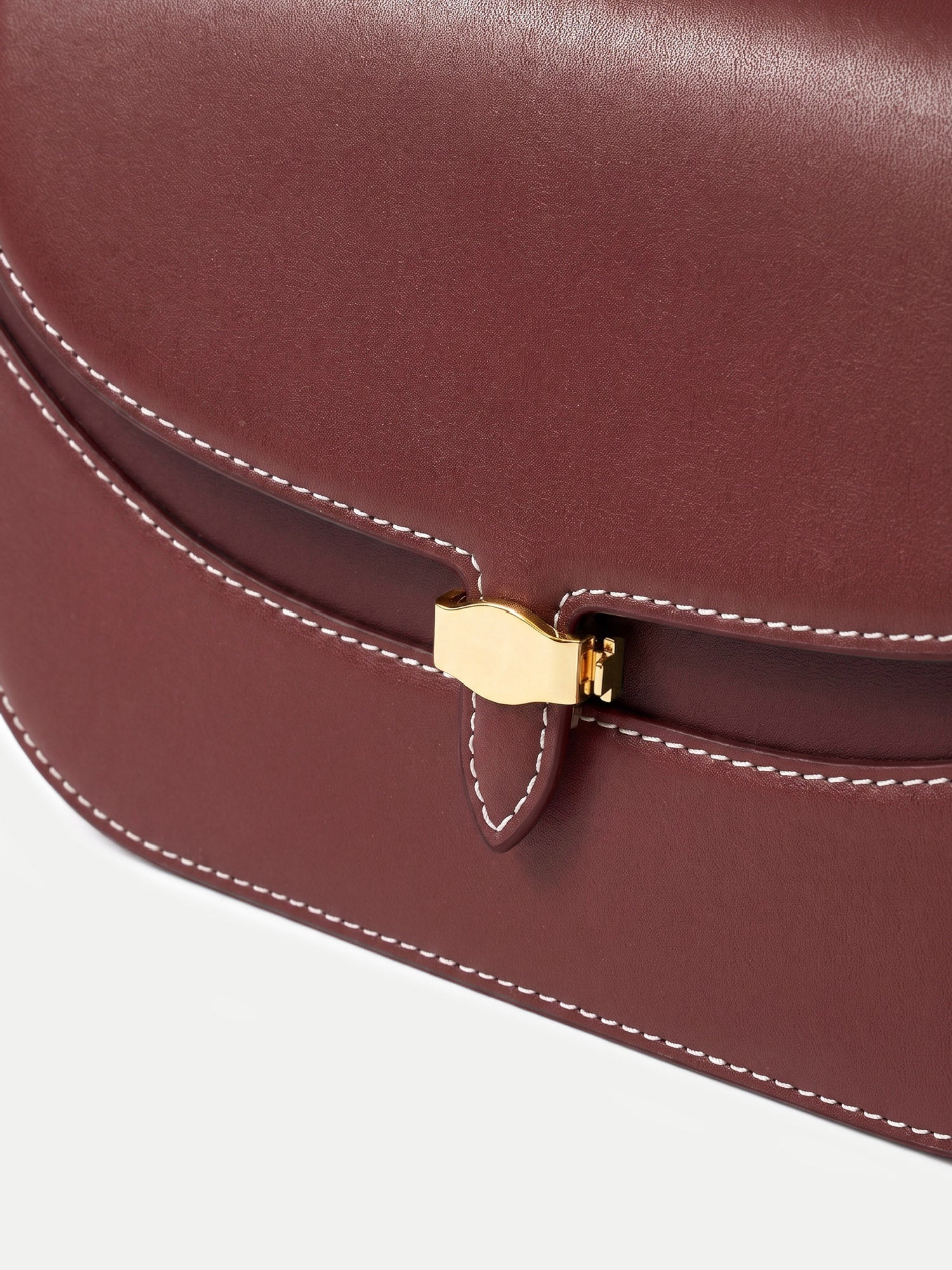 Veronica Beard Burgundy leather handbag with white stitching and clasp.