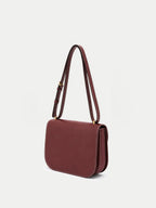 Veronica Beard Burgundy leather structured crossbody handbag with white stitching.