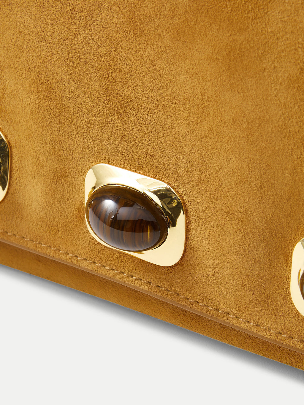 Veronica Beard Tan suede handbag with gold-rimmed brown gemstone embellishment.