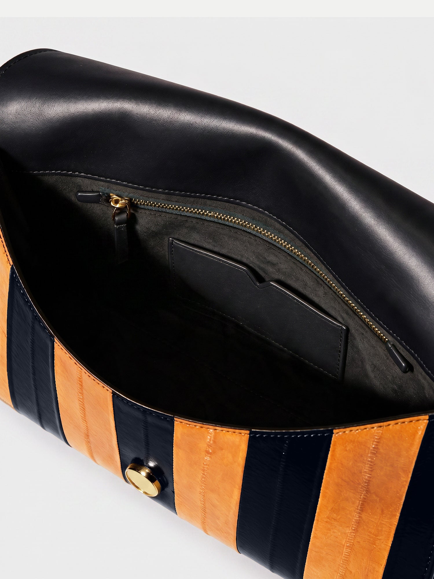 Veronica Beard Black and orange striped leather clutch bag interior.