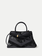 Veronica Beard Black leather chevron handbag with gold clasp.