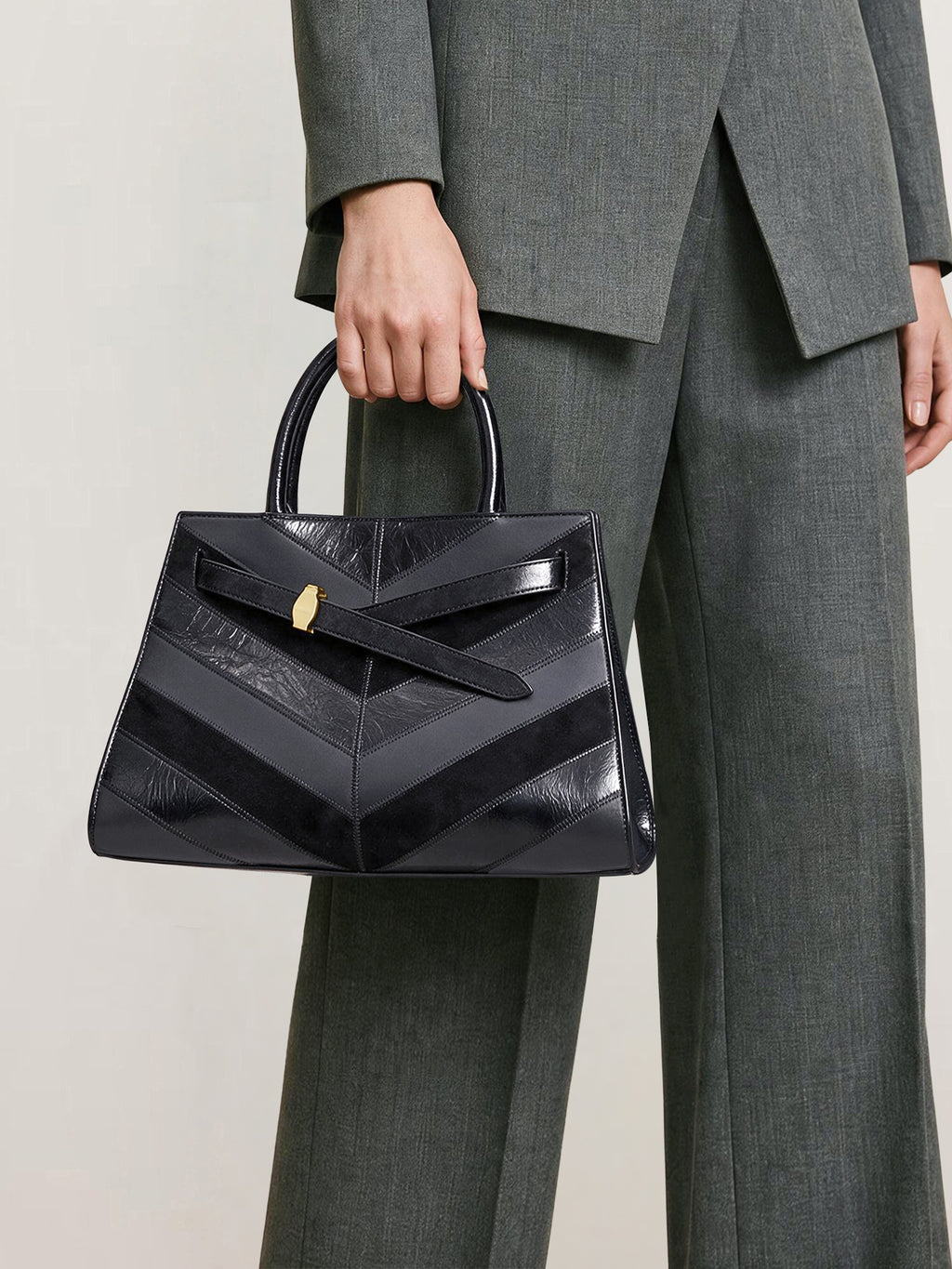 Veronica Beard Black leather handbag, chevron pattern, structured trapezoid silhouette.