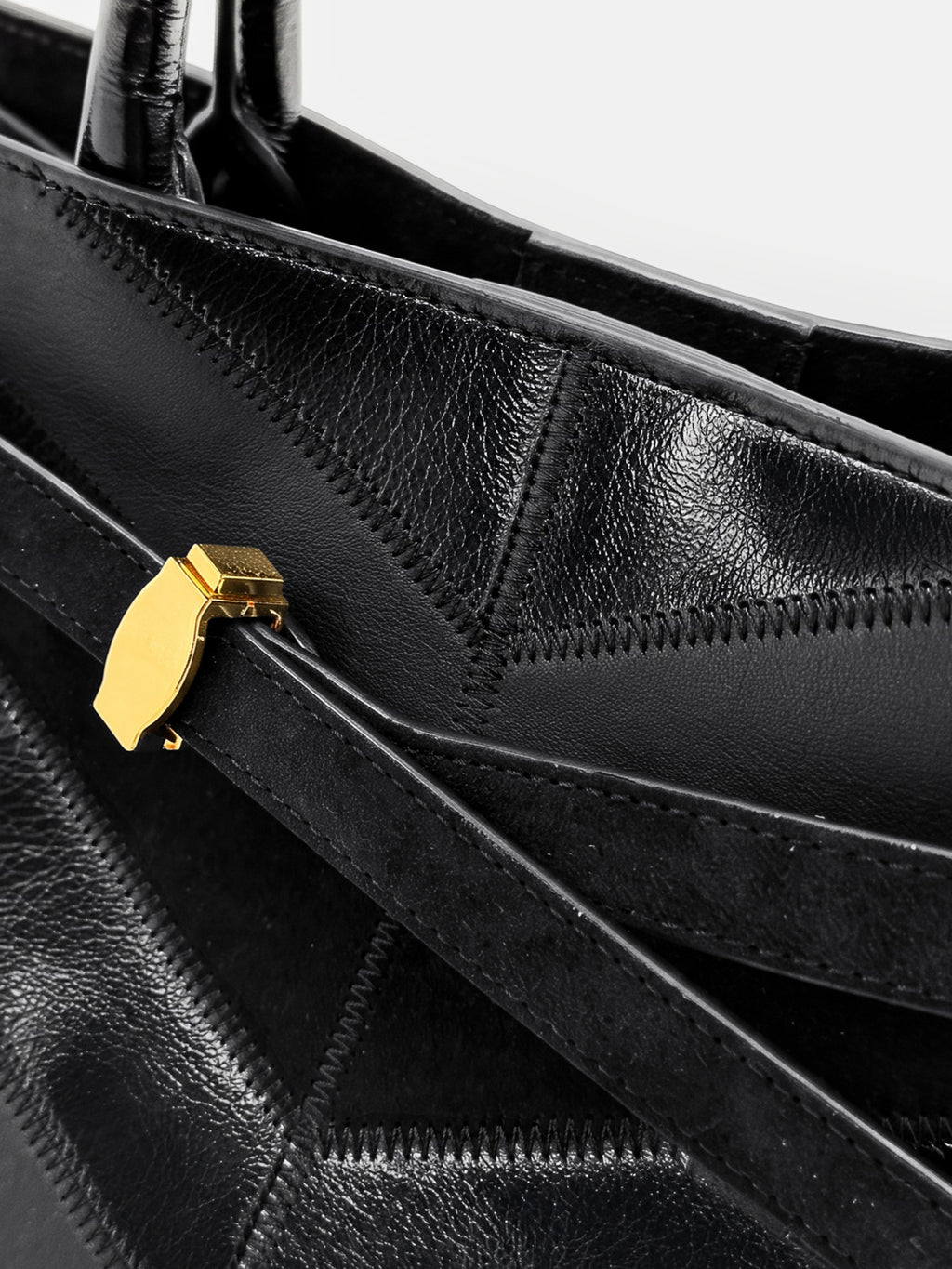 Veronica Beard Black leather patchwork tote bag with gold hardware.