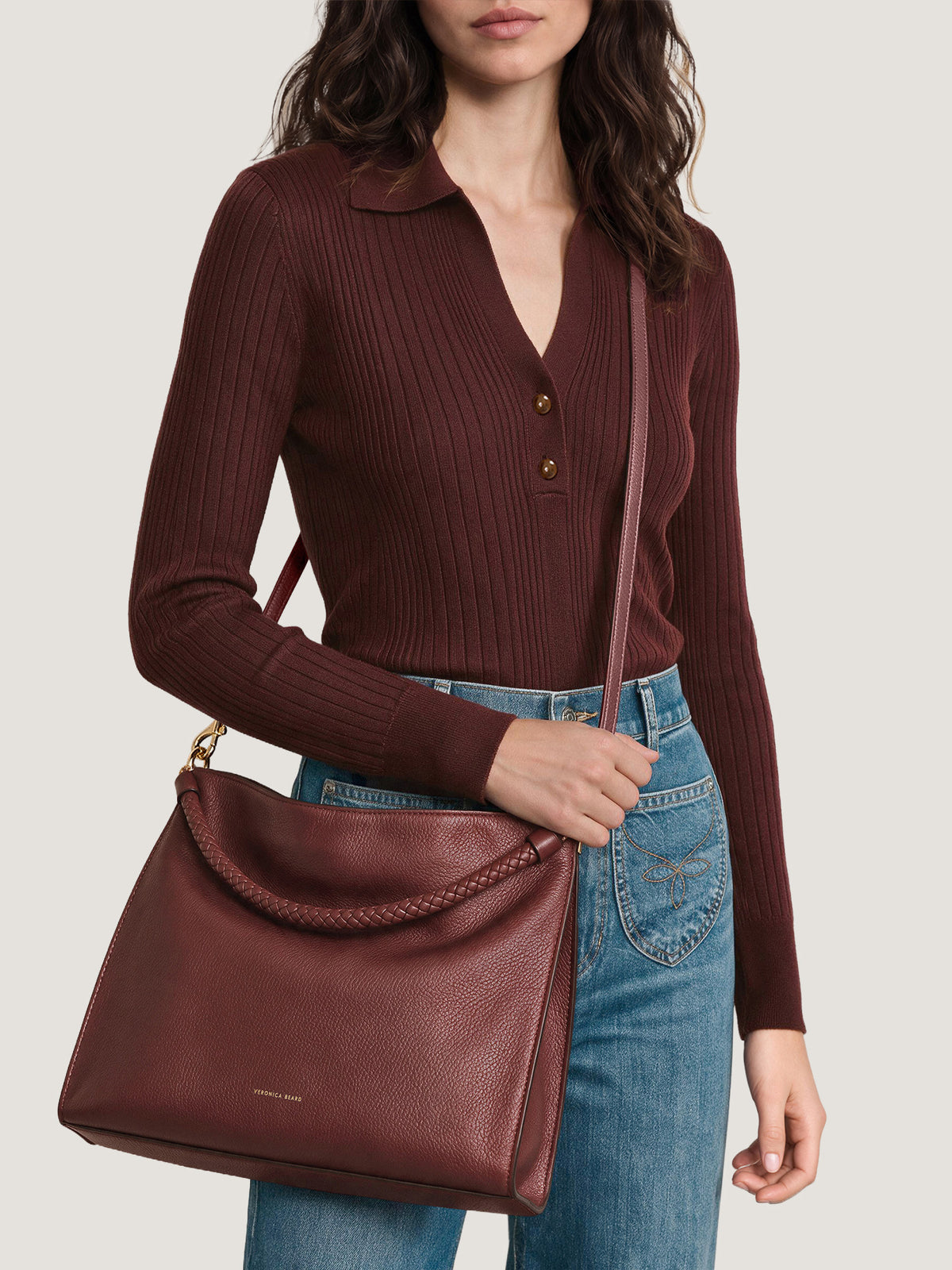 Veronica Beard Burgundy ribbed polo sweater and leather shoulder bag.