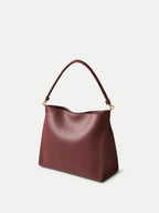 Veronica Beard Burgundy leather shoulder bag with braided handle.
