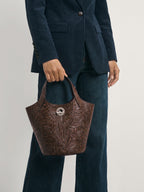 Veronica Beard Brown embossed leather handbag with circular logo detail.