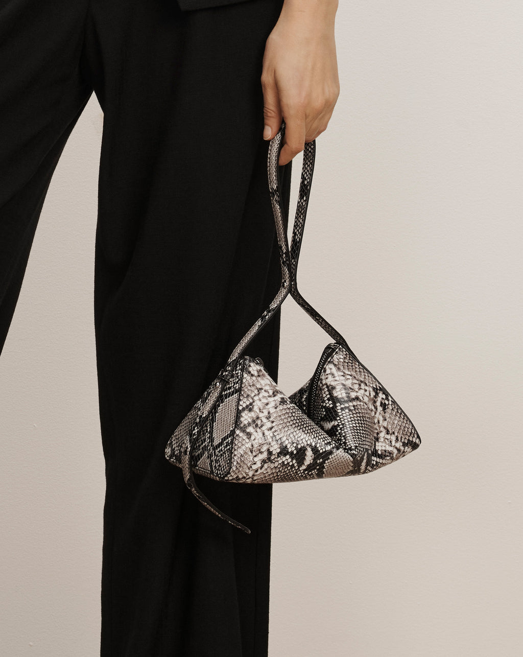 Veronica Beard Black snakeskin triangular handbag with shoulder strap.