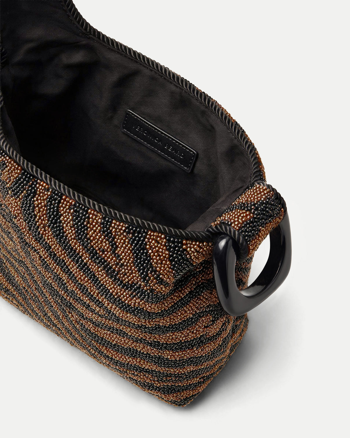 Veronica Beard Beaded zebra-print handbag with black ring handle.