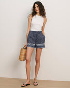 Veronica Beard White ribbed tank top and navy blue patterned shorts with a light-colored trim.
