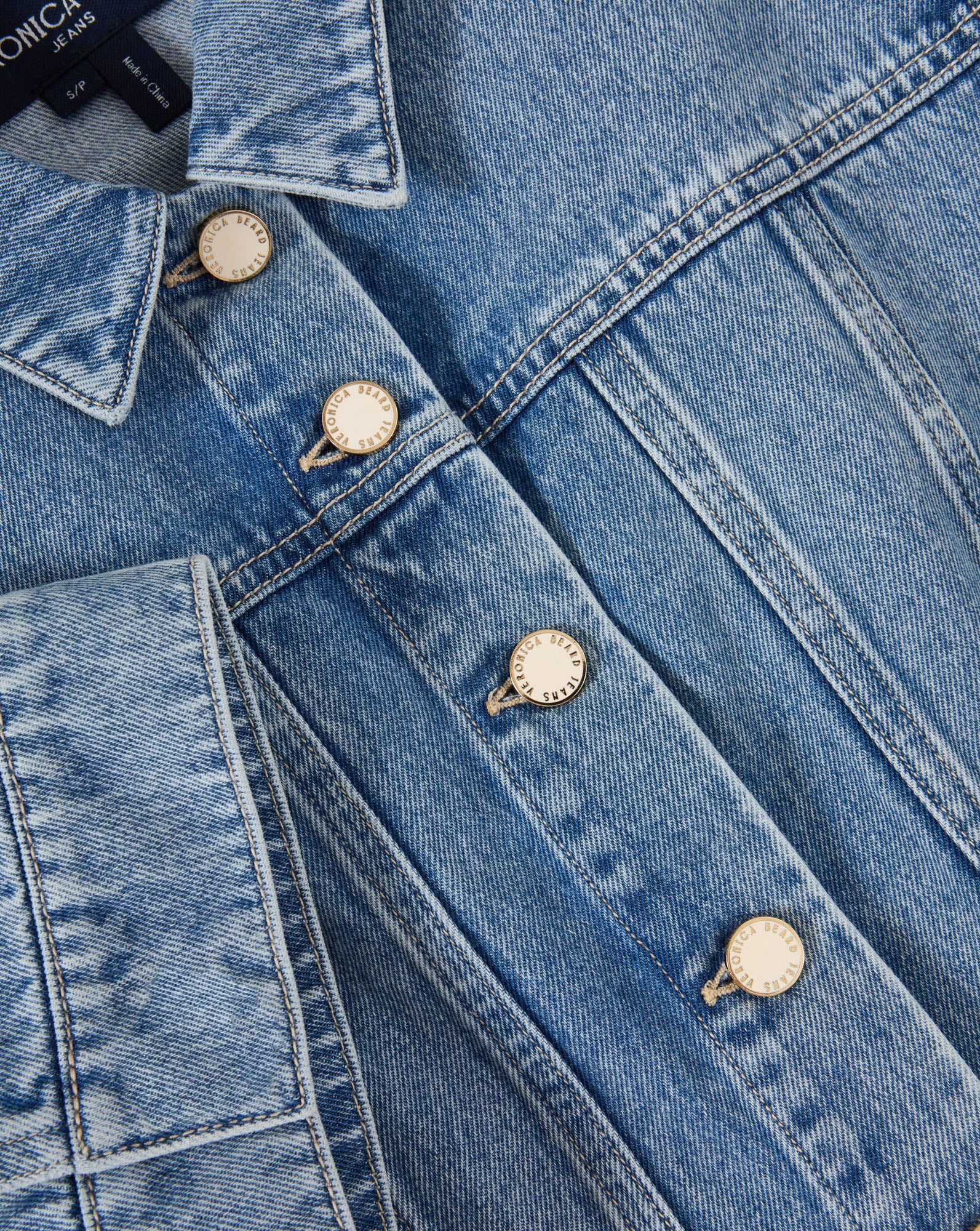 Veronica Beard Light wash denim short-sleeve button-up shirt and matching mini skirt.