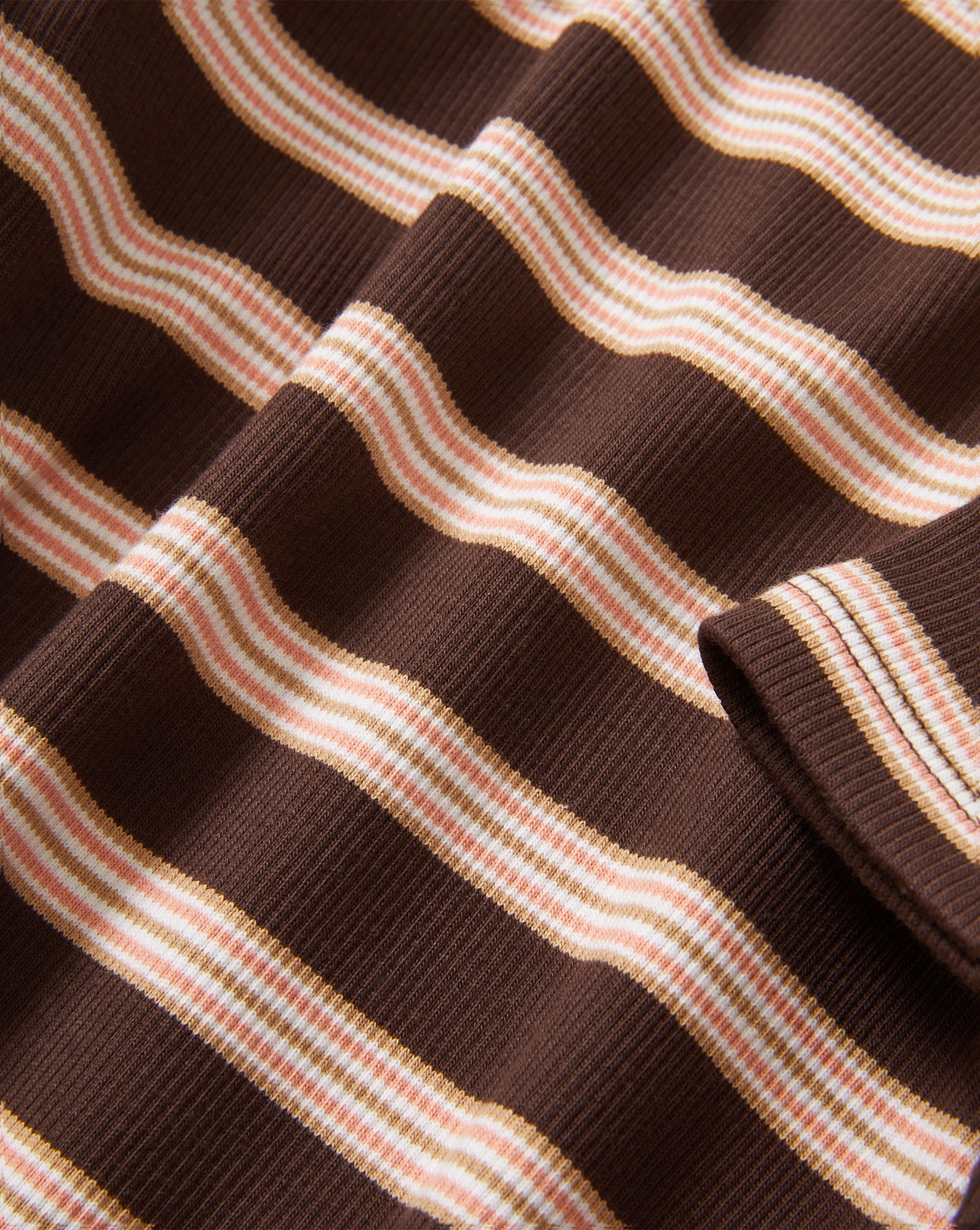Veronica Beard Brown and pink striped knit t-shirt with light wash wide-leg jeans.