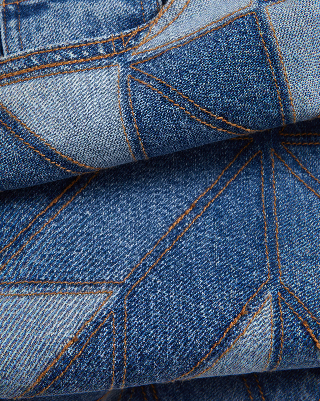 Veronica Beard Blue patchwork jeans with orange stitching.