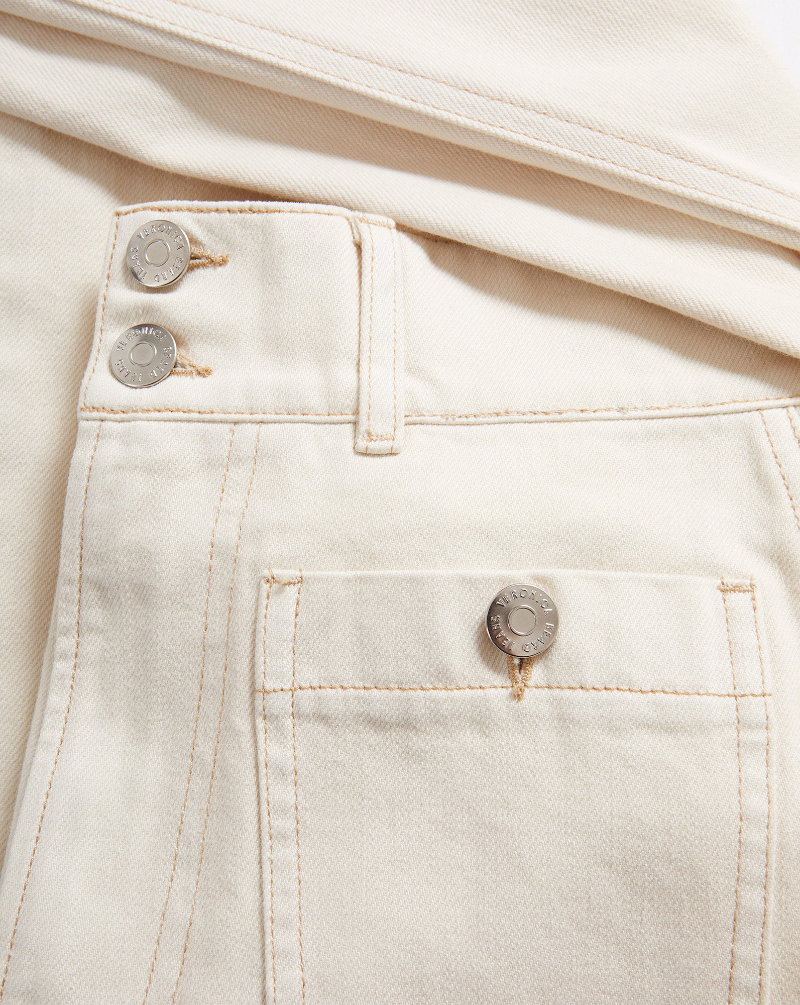 Veronica Beard Cream denim jeans with button fly and patch pocket.