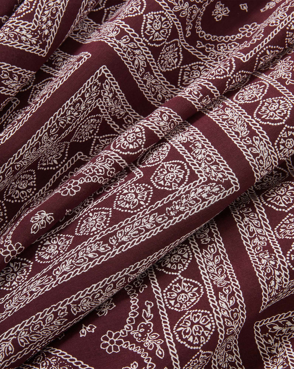 Veronica Beard Maroon bandana print fabric with white paisley pattern.