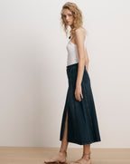 Veronica Beard White tank top, dark wash denim midi skirt.