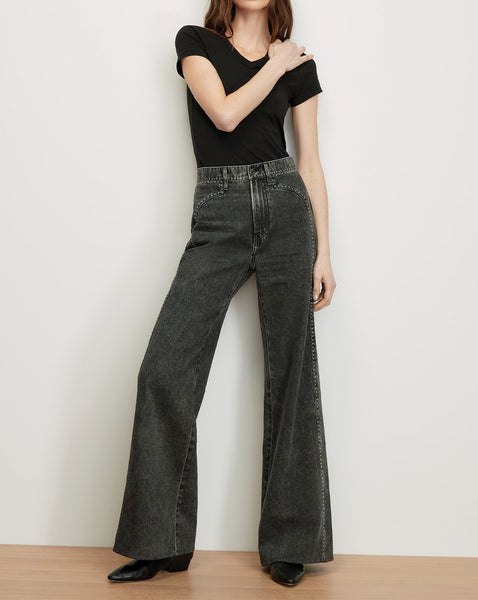 Veronica Beard Black V-neck t-shirt and dark wash flared jeans.