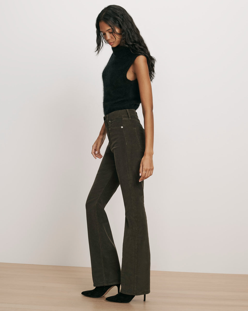 Veronica Beard Black sleeveless turtleneck sweater and flared corduroy pants.