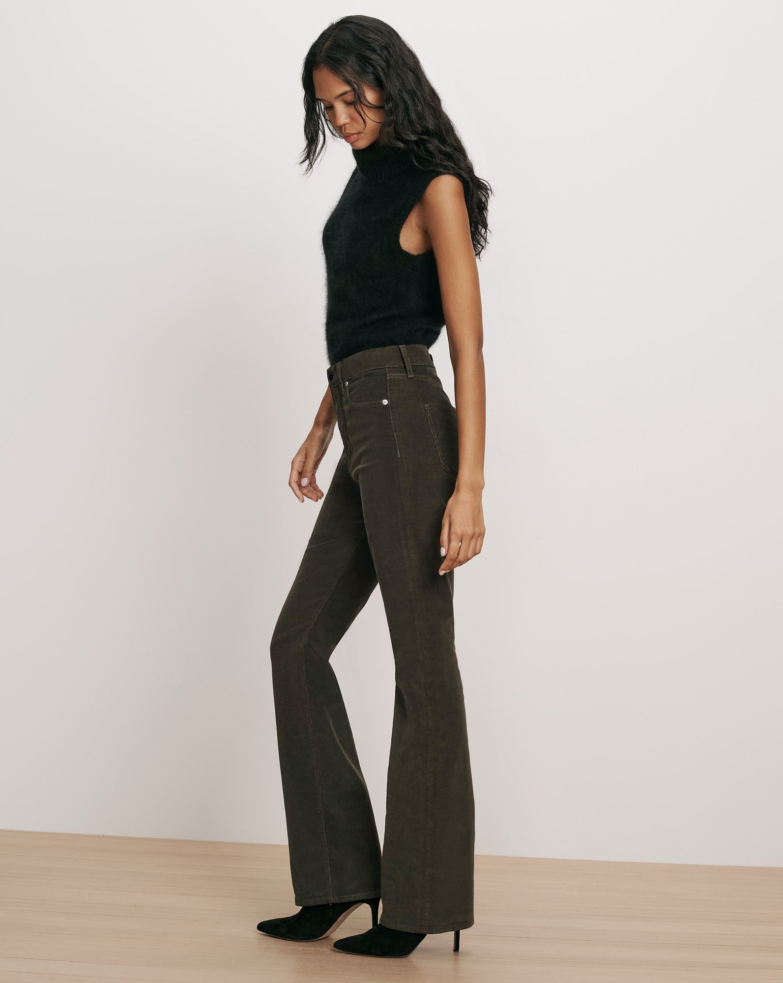 Veronica Beard Black sleeveless turtleneck sweater and flared corduroy pants.