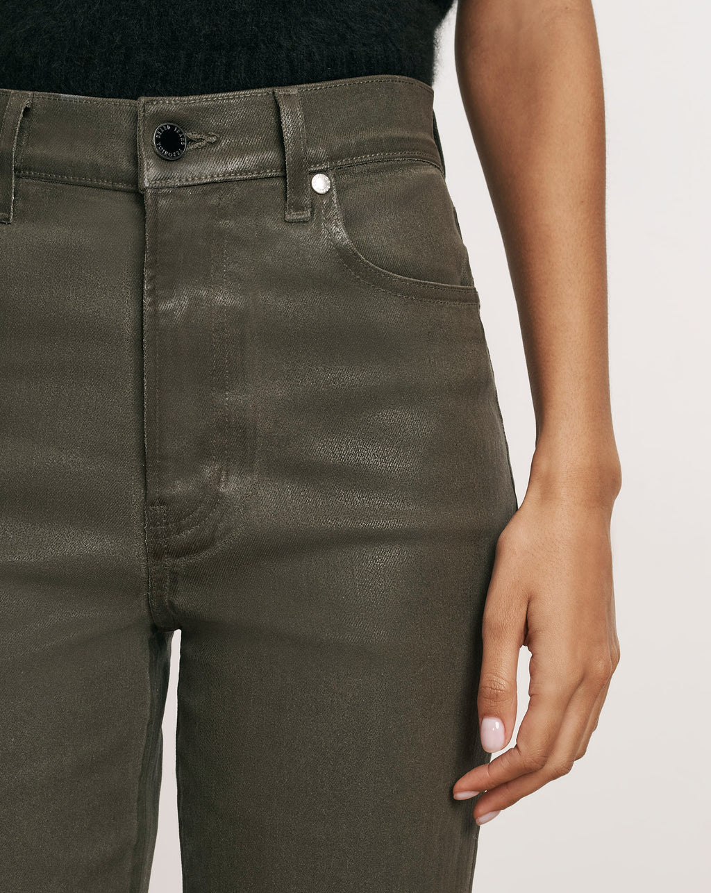 Veronica Beard Dark olive green coated high-waisted denim jeans.