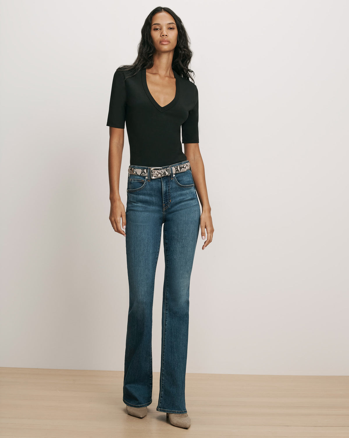 Veronica Beard Black short-sleeve V-neck top and blue jeans.