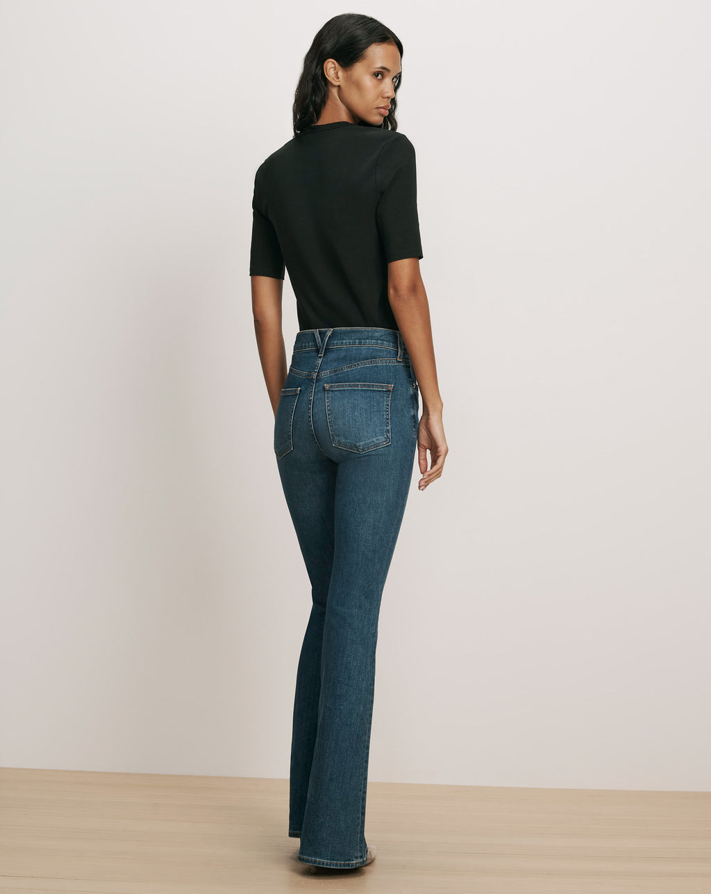 Veronica Beard Black t-shirt and blue flared jeans.