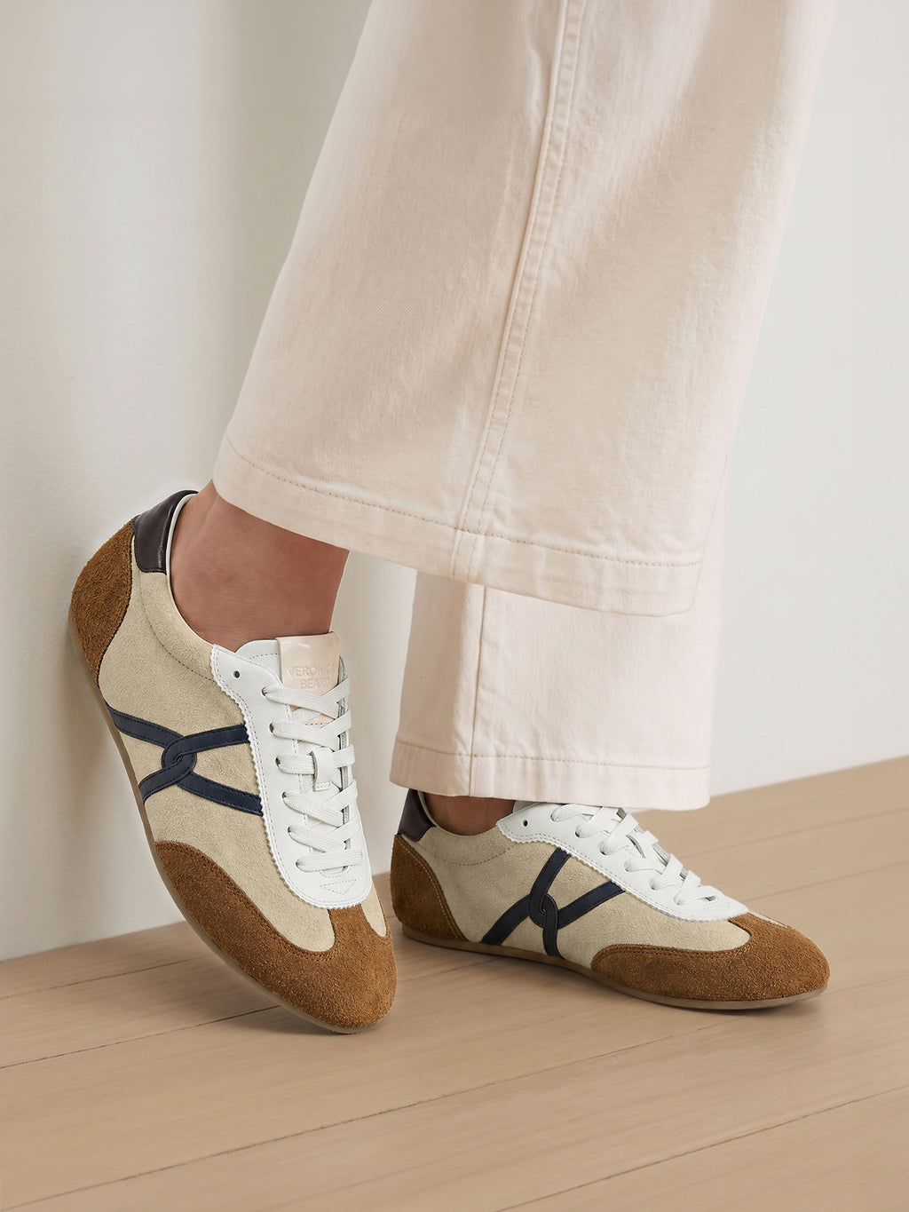 Veronica Beard Beige and brown suede sneakers with navy blue stripes.