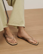 Veronica Beard Beige square-toe flat sandals with clear PVC thong straps.