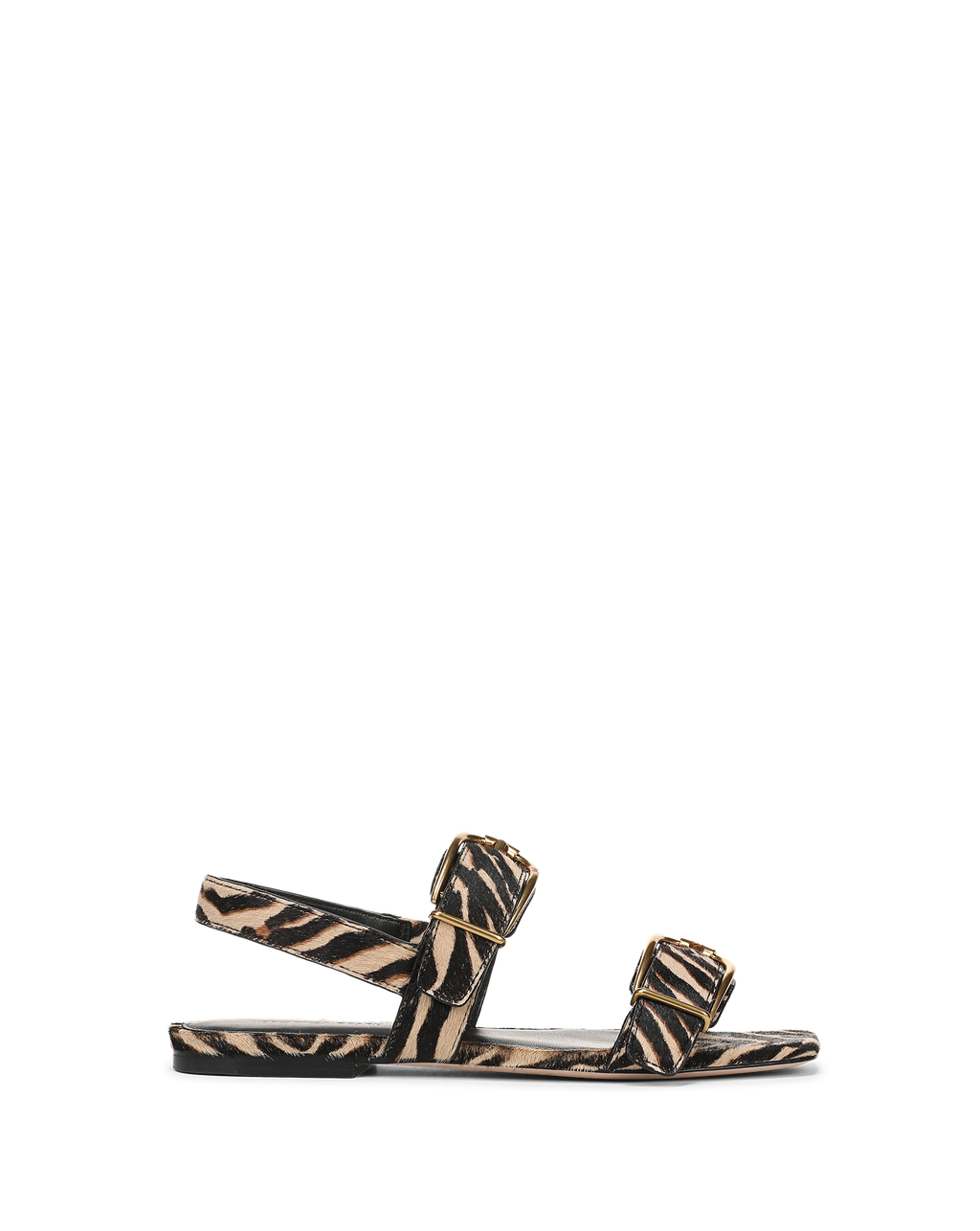 Veronica Beard Zebra print calf hair flat sandals with gold buckles.