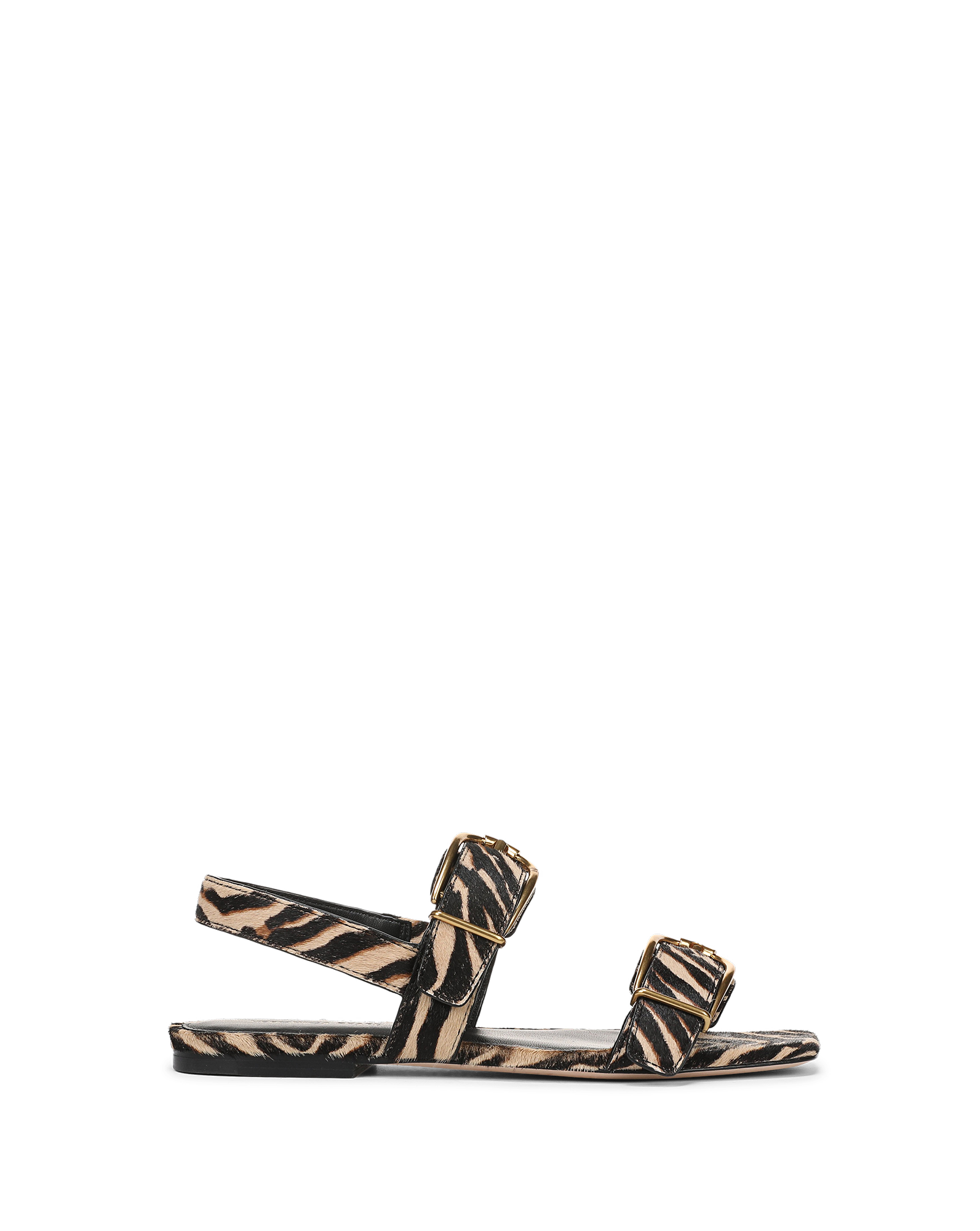 Veronica Beard Zebra print calf hair flat sandals with gold buckles.