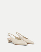 Veronica Beard Cream leather slingback pumps with pointed toes and block heels.