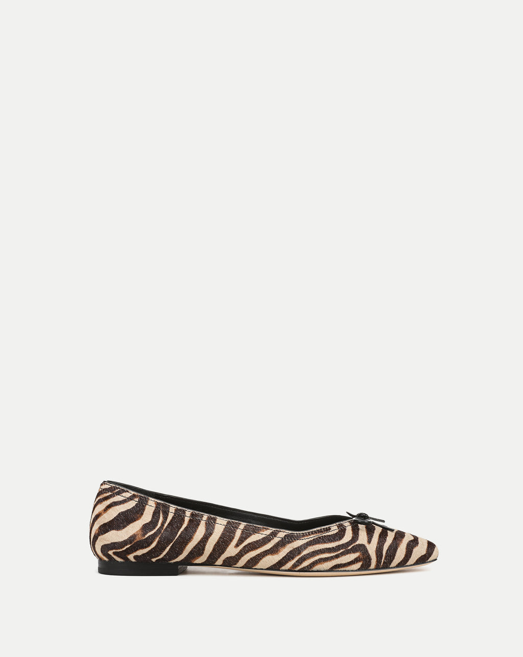 Veronica Beard Zebra print pointed-toe flats with small bow detail.