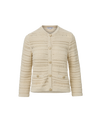 Veronica Beard Cream open-knit cardigan and light wash flared jeans.